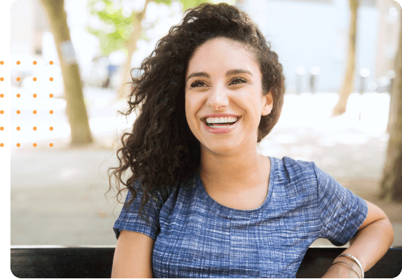 Smiling woman sitting on a park bench